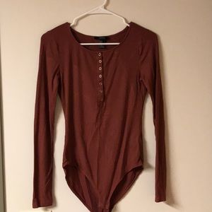 Long sleeved maroon body suit